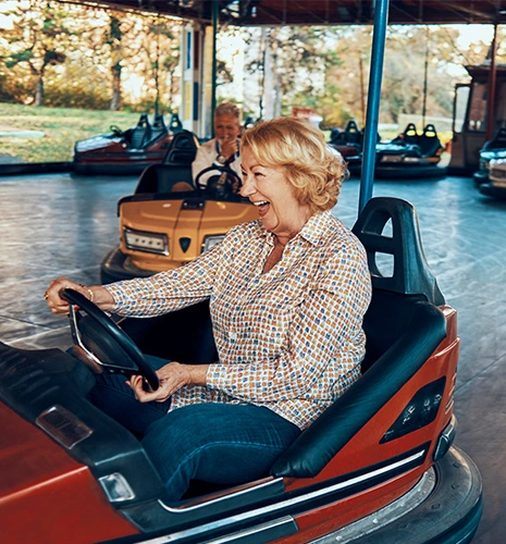 Smiling senior in a bumper car