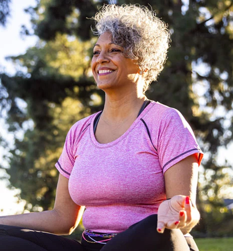 Smiling senior in a meditation pose