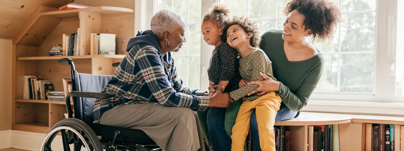 senior woman in wheelchair meeting with family
