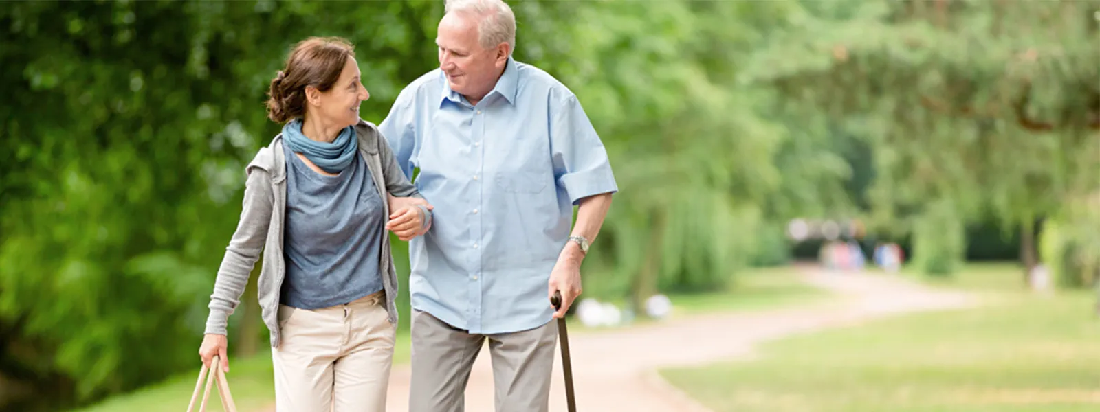 Caregiver woman helping senior man with shopping