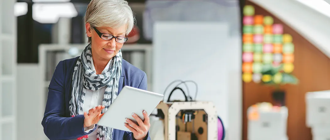 Middle aged woman looking at her tablet