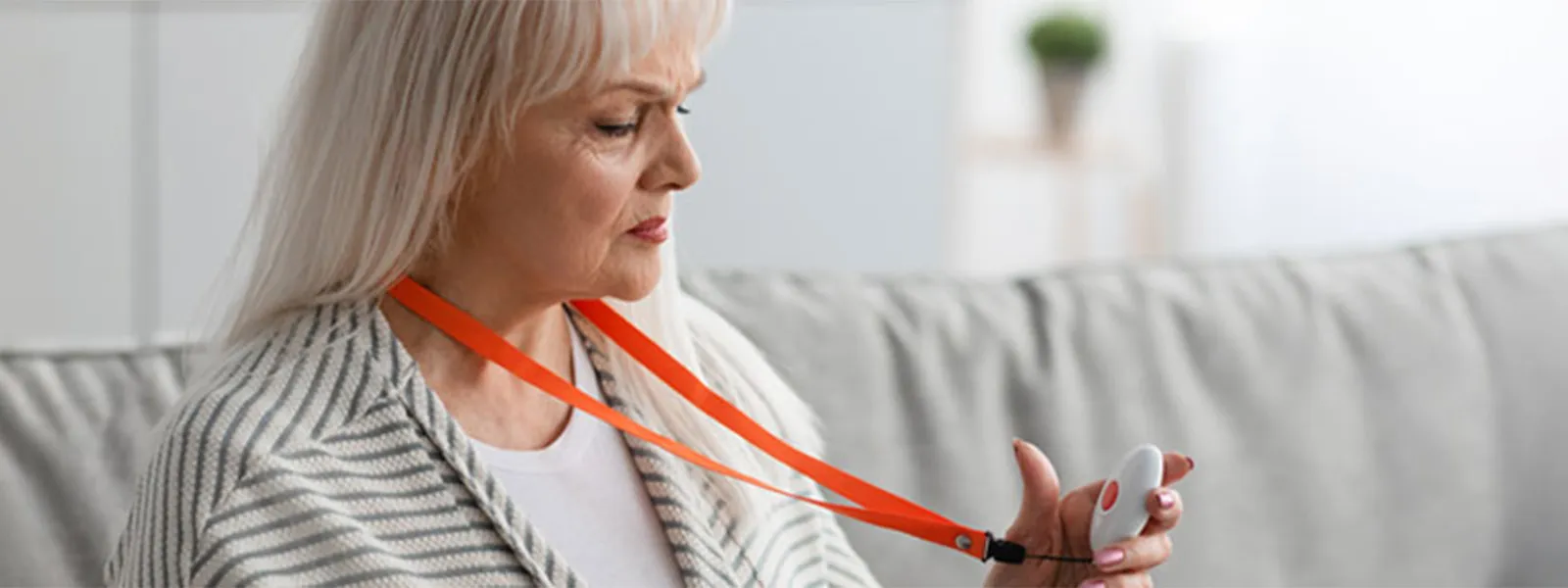 Senior woman holding alarm button.