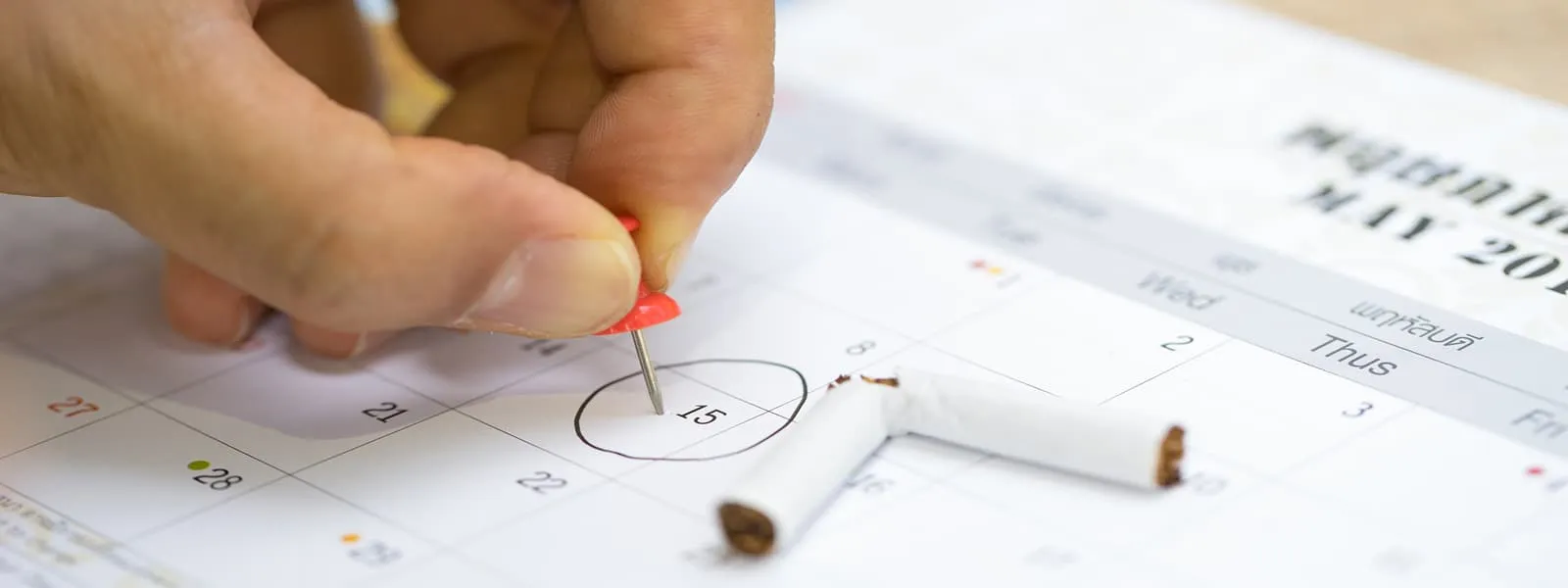 Person choose a date on calendar to quit smoking