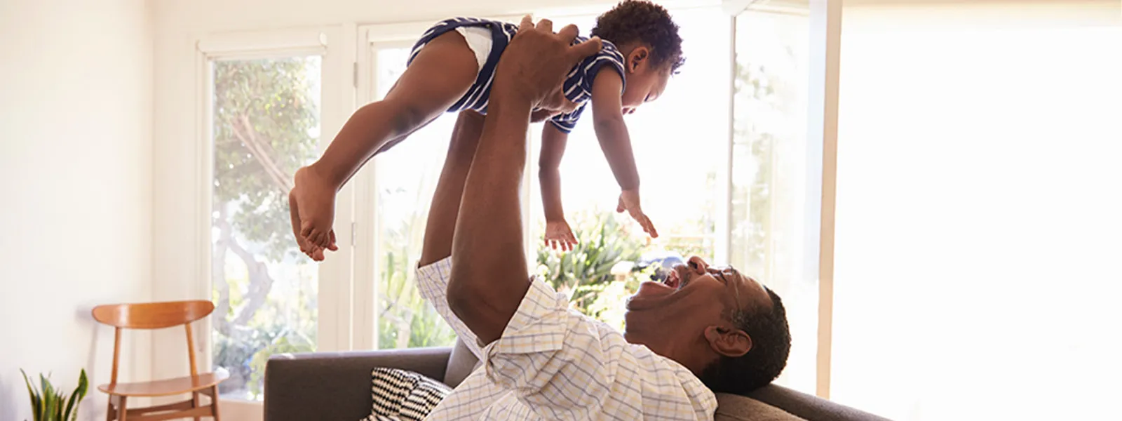 Grandpa playing with grandson in the living room.