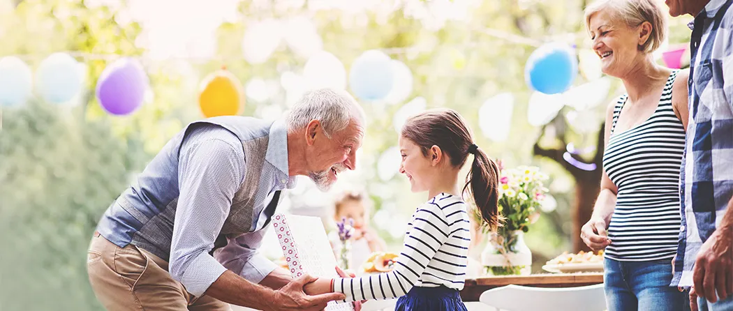 Grandpa giving his granddaughter a present