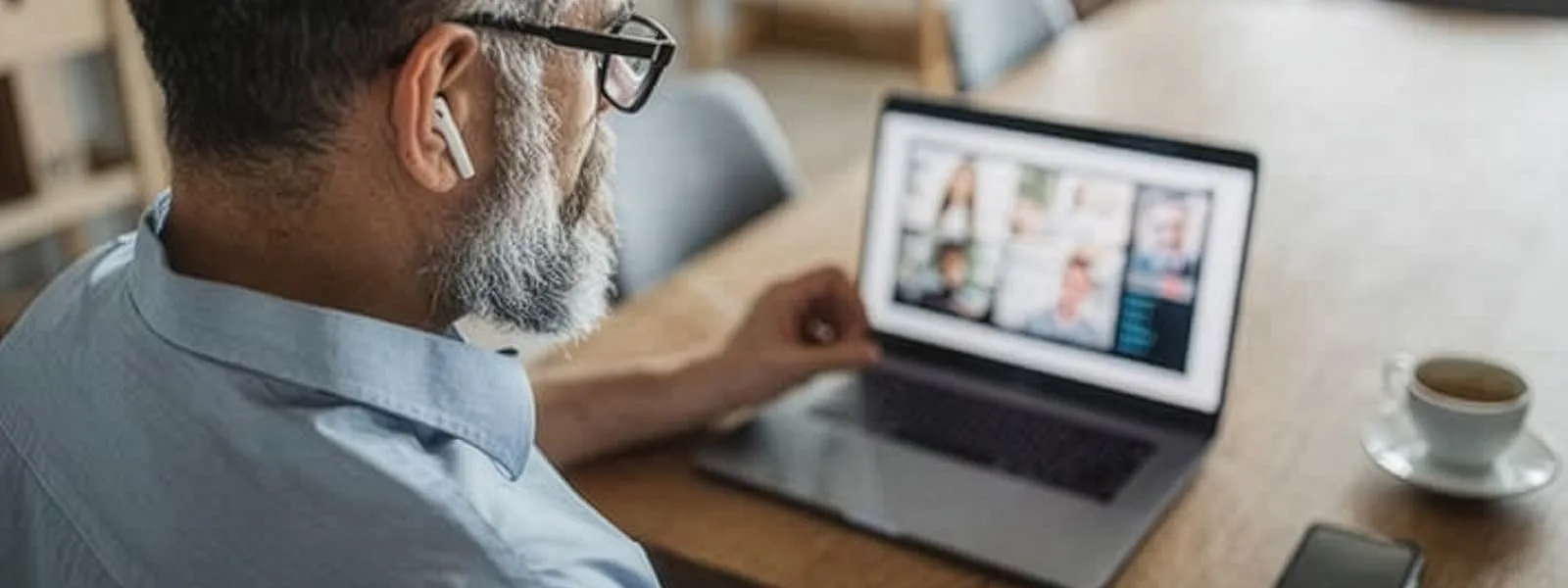 A man is sitting at his computer on a virtual call