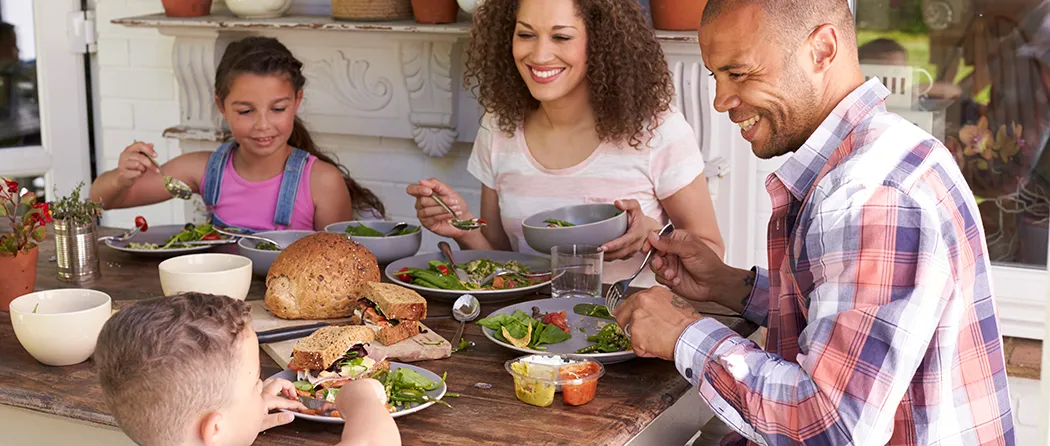 Family sitting around the table enjoying some lunch