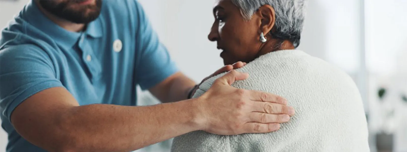 A senior woman being examined by her chiropractor.