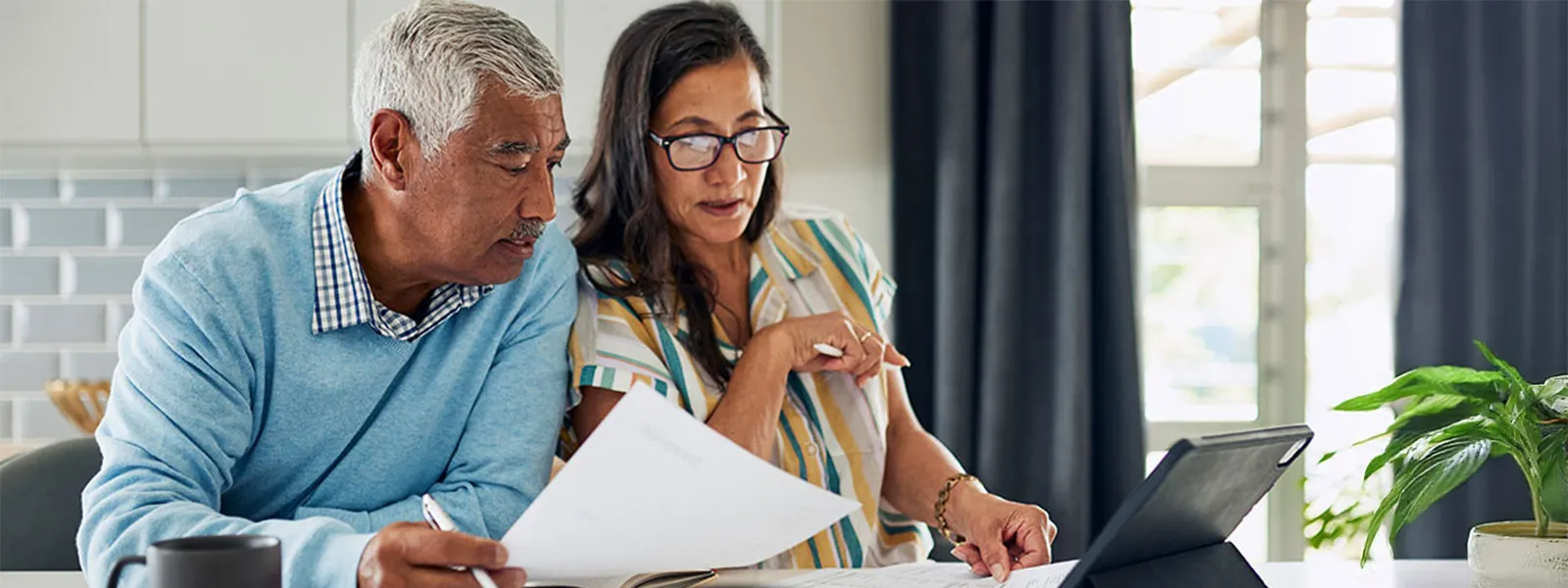 couple going through documents and computer