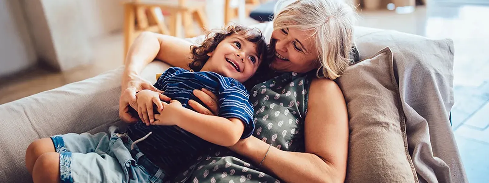 Grandma and grandson laughing on the couch