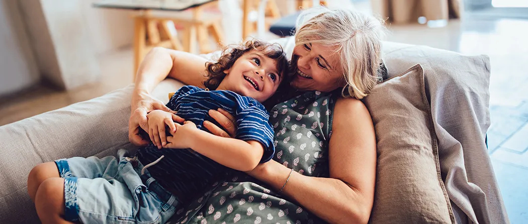 Grandma and grandson laughing on the couch