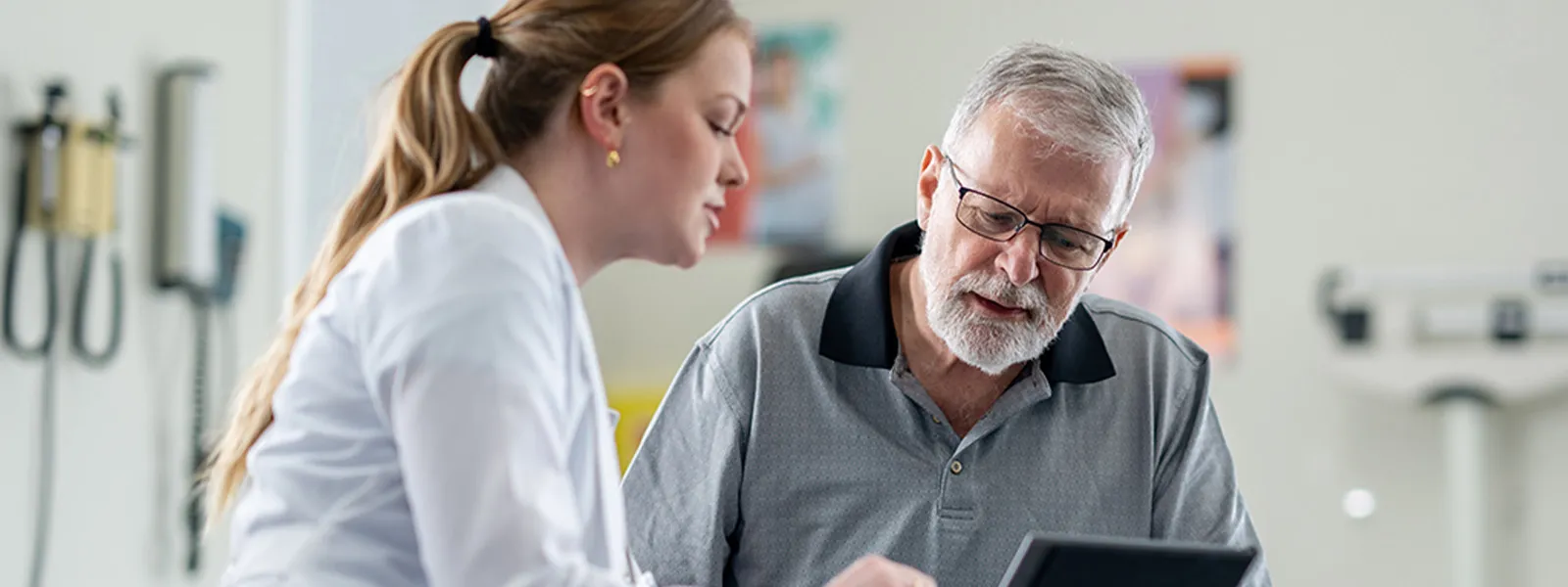 A senior gentleman meets with his female doctor to discuss his health concerns.