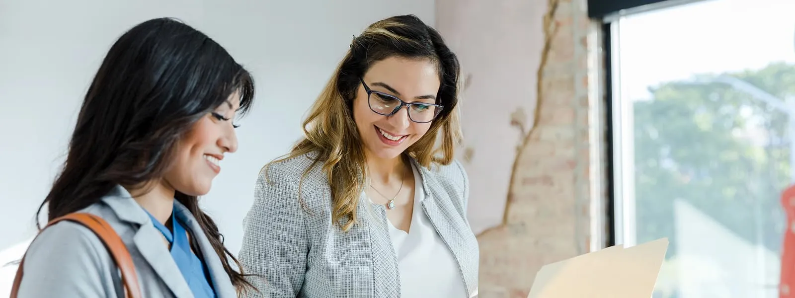 Woman looking over a mans resume in an interview
