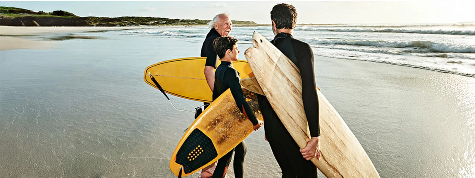 Grandfather with son and grandson surfing 