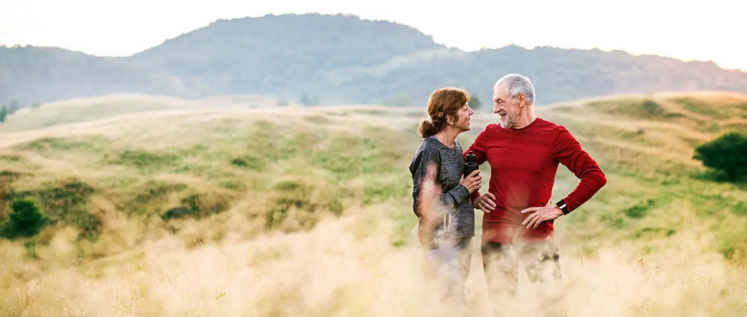 Older couple standing in a field
