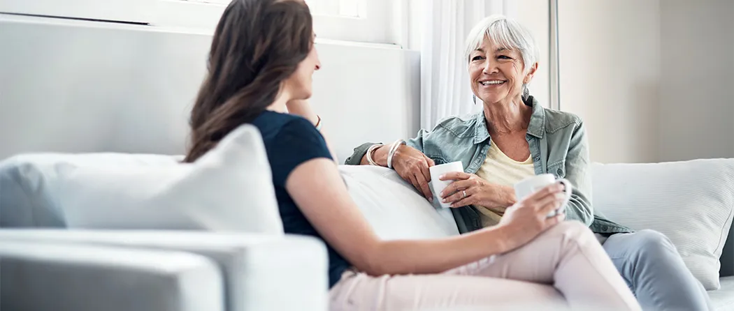 Mother and daughter talking on the couch