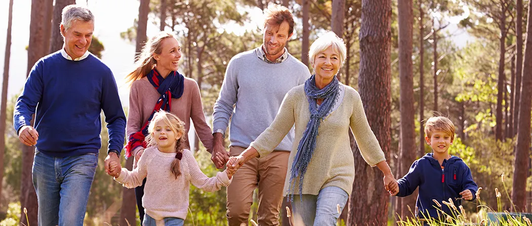 3 Generations talking a walk through a forest