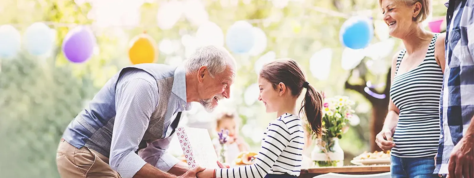 Grandpa giving his granddaughter a present