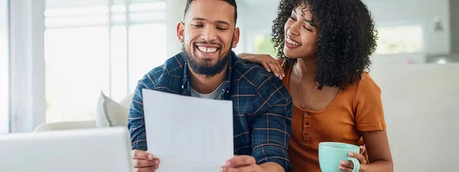 Couple reading a paper together and smiling