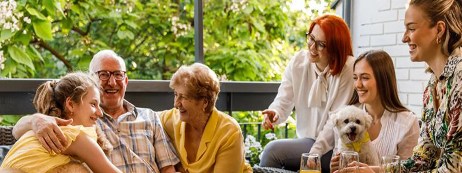 A family sitting on the front porch.