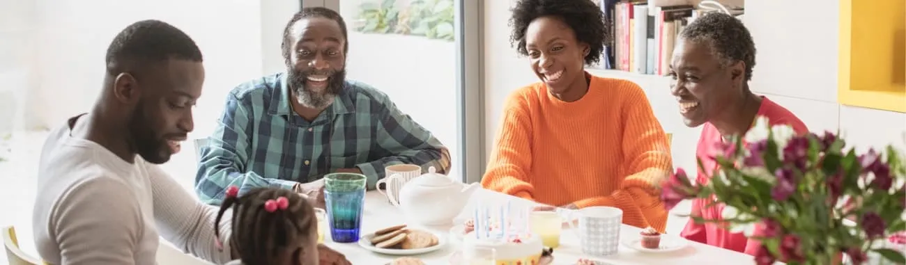 Family sitting at kitchen table. 