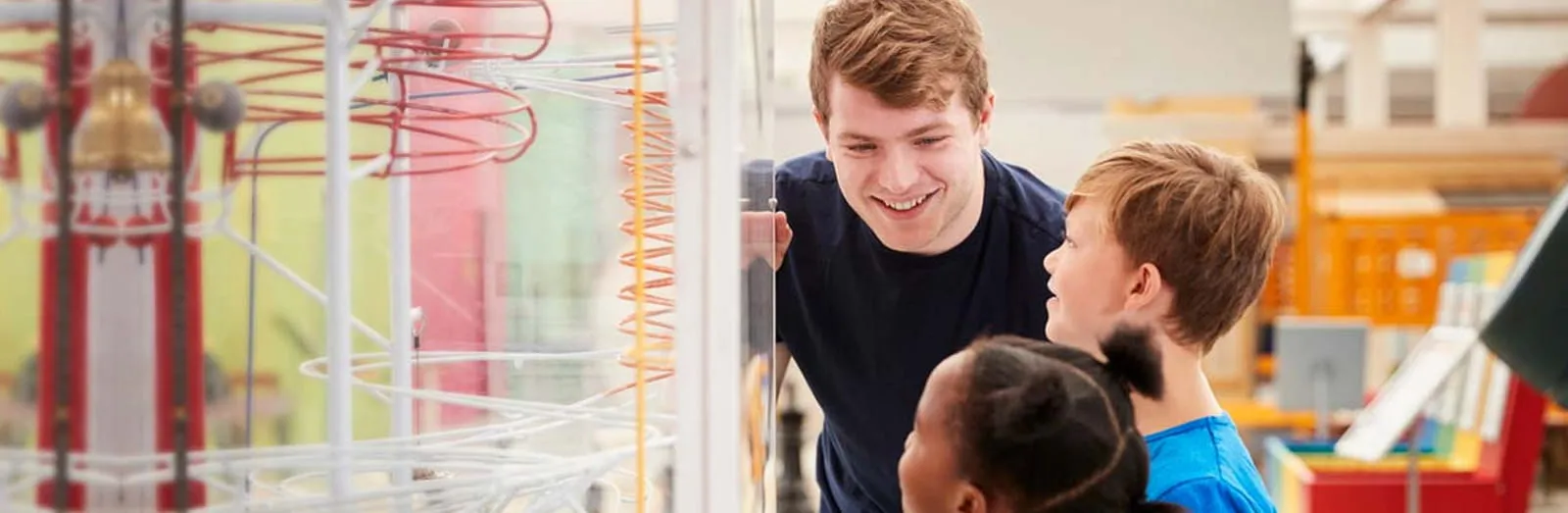 Man with children looking at a museum exhibit