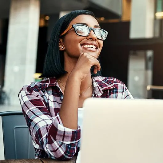girl wearing glasses at computer