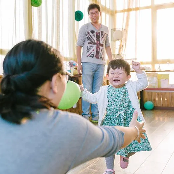 Mom and dad and kid playing