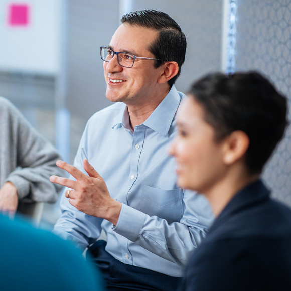 man talking to coworkers in a circle