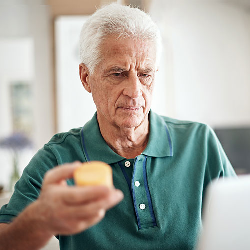 man looking at prescriptions man looking at prescriptions