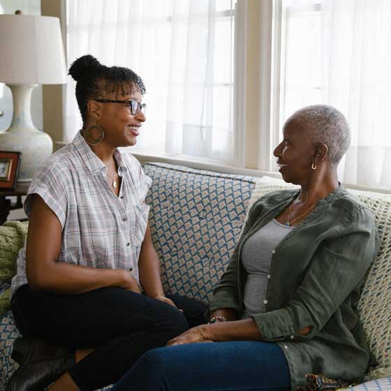 mother and daughter sitting on sofa