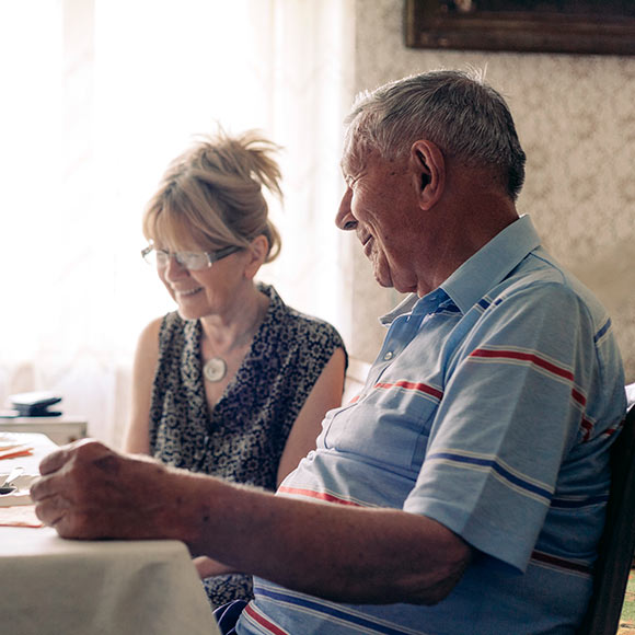Smiling couple discussing life insurance needs