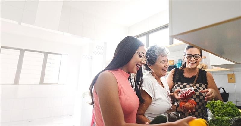 a family in the kitchen having fun together while unloading groceries