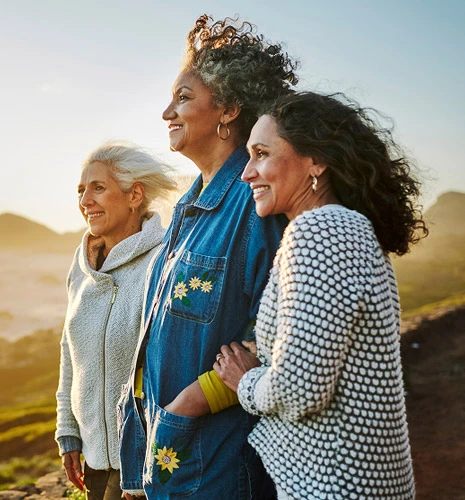 Three women hiking on a trail