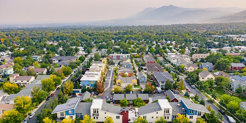 An aerial view of the Silver Sage Village senior cohousing community in Boulder, Colorado, with the Rocky Mountains in the background.
