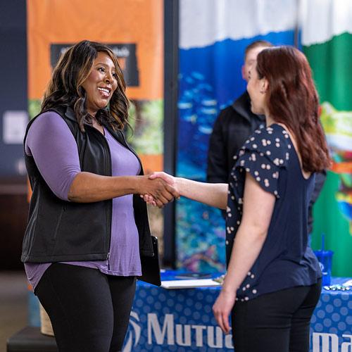 Congratulating a new hire Women shaking hands