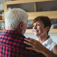 Whole life insurance customer, Evelyn embraces her husband.