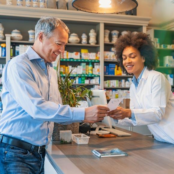 A man checking prescription with pharmacist