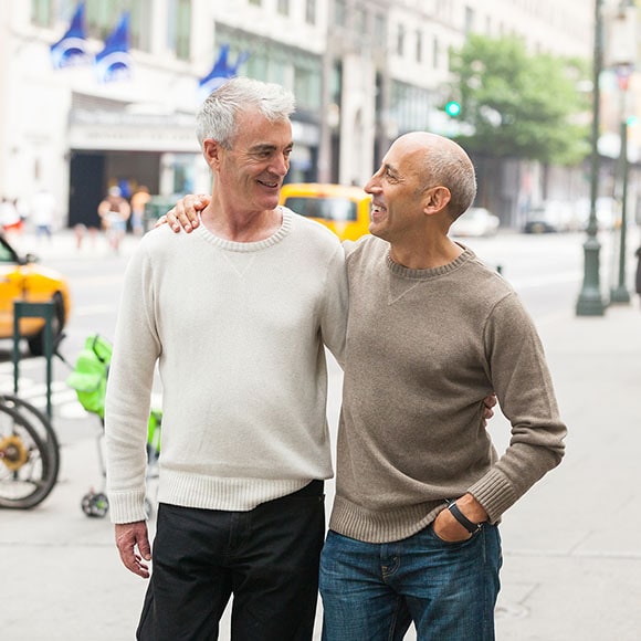 Same-sex couple covered by a Medicare supplement plan walking down a street