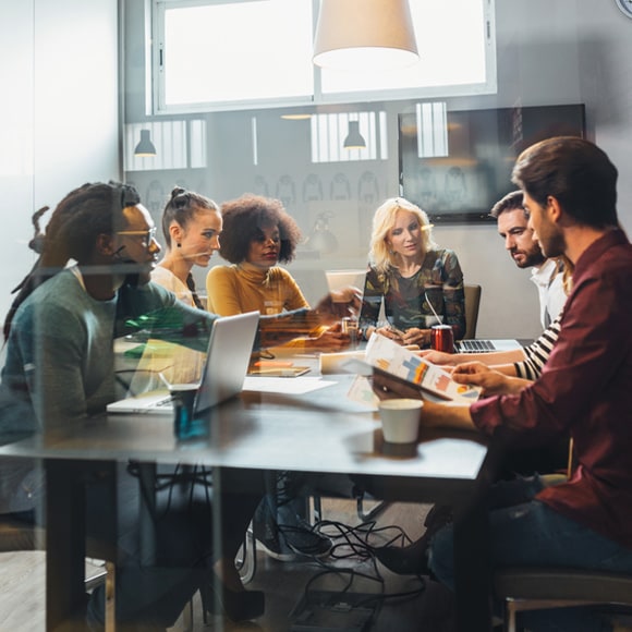 group of coworkers sitting as table collaborating 