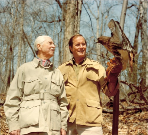 Marlin Perkins standing next to Jim Fowler holding a Falcon