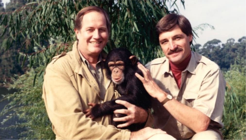 Jim Fowler and Peter Gros holding a monkey