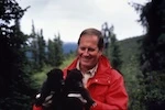 Thumbnail - Jim Fowler holds a pair of black bear cubs while filming Wild Kingdom