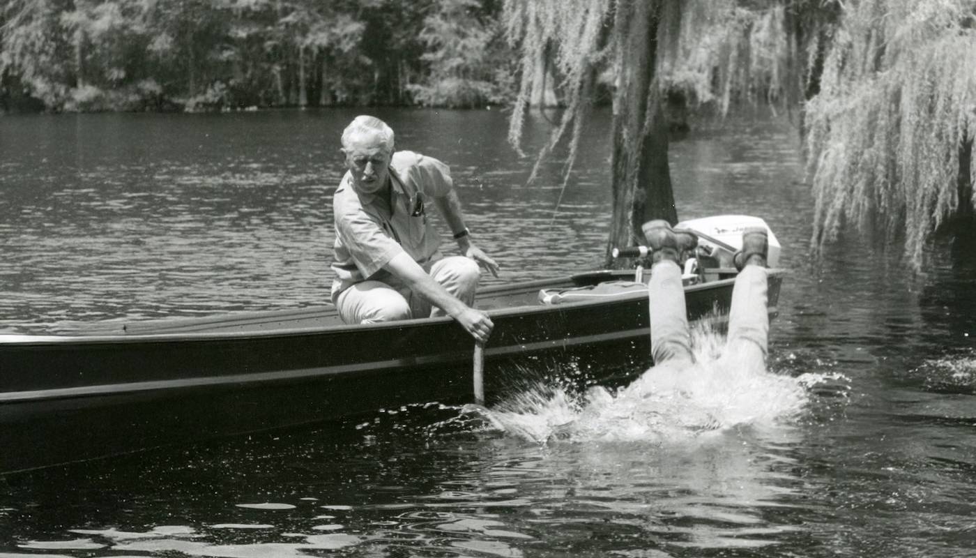 Black and white vintage image: early screen shot from a classic episode of Mutual of Omaha’s Wild Kingdom. Host Marlin Perkins watches as host Jim Fowler goes overboard into the water.