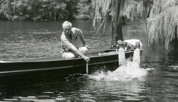 Black and white vintage image: early screen shot from a classic episode of Mutual of Omaha’s Wild Kingdom. Host Marlin Perkins watches as host Jim Fowler goes overboard into the water.